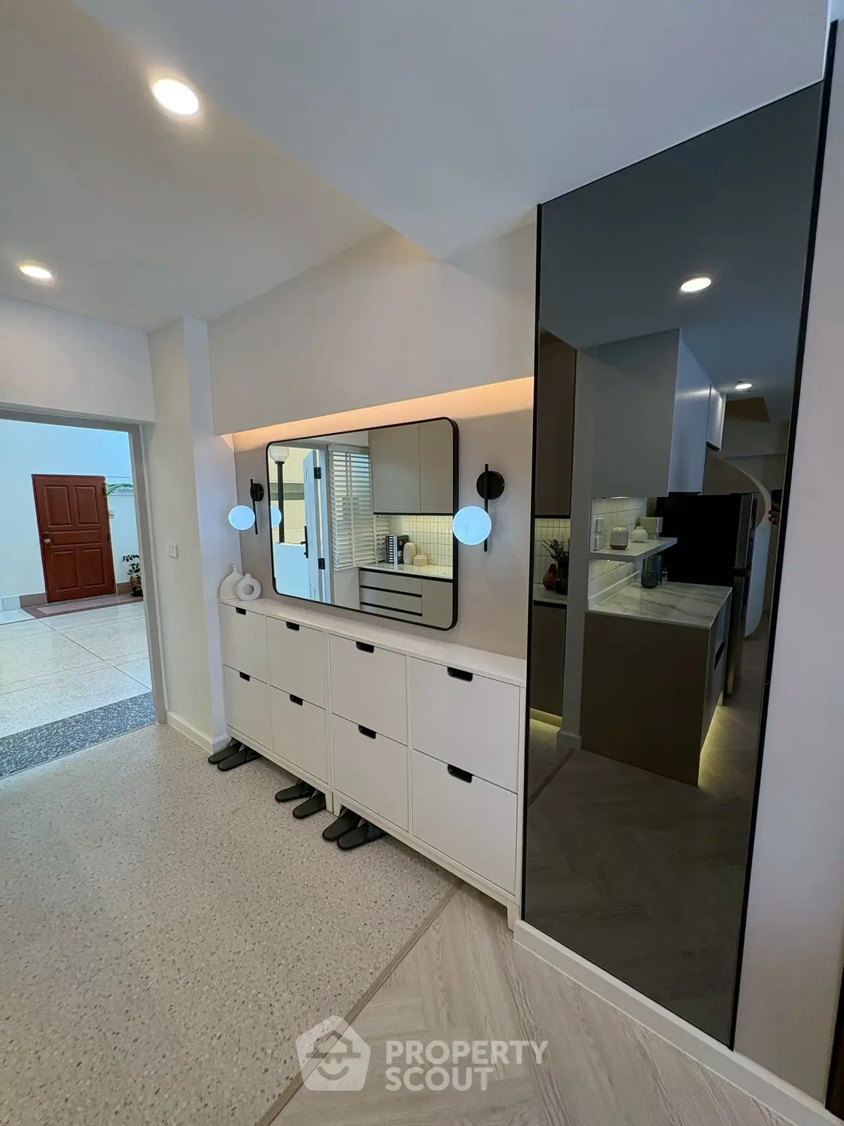 Modern hallway with sleek storage and stylish lighting in contemporary home