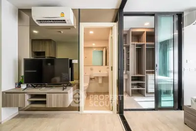 Modern apartment interior with open living area, bathroom, and bedroom featuring sleek design and ample storage.