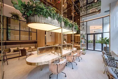 Luxurious modern lobby with elegant seating and lush greenery, perfect for welcoming guests in style.