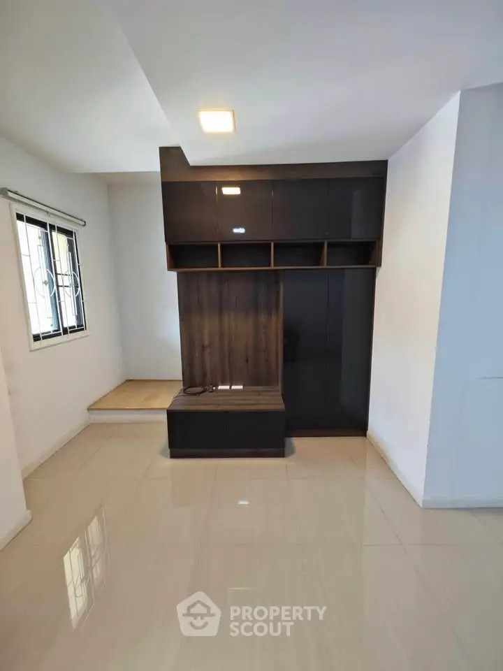 Modern living room with sleek built-in storage and glossy flooring