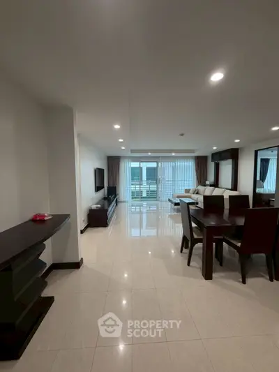 Spacious modern living room with elegant dining area and large windows for natural light.
