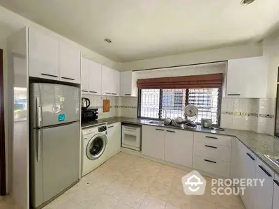 Spacious kitchen with modern appliances and ample storage space