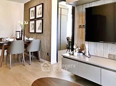 Modern living room with stylish dining area and wall-mounted TV, featuring elegant decor and wooden accents.