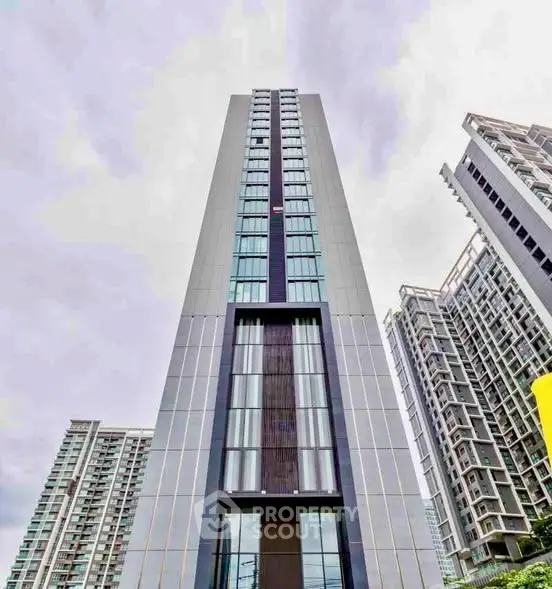 Stunning modern high-rise building with sleek architectural design and expansive glass windows.