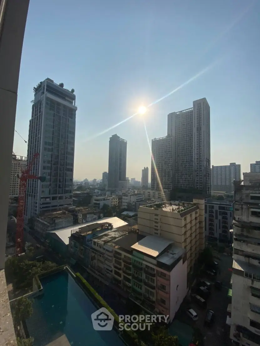 Stunning cityscape view from high-rise building with pool and skyline