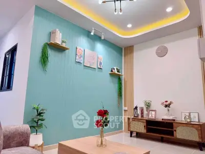 Modern living room with stylish decor and accent lighting, featuring a cozy seating area and elegant wall art.