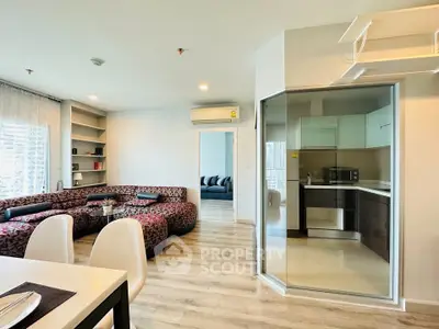 Modern open-plan living room with stylish kitchen and cozy seating area