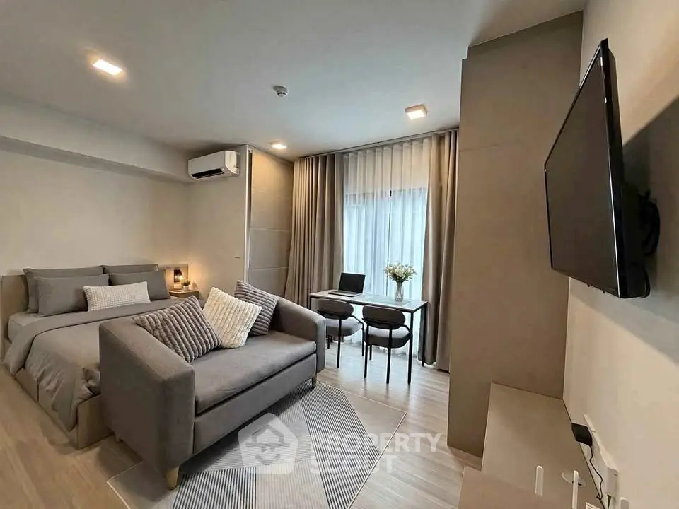 Modern studio apartment with cozy living area and stylish decor