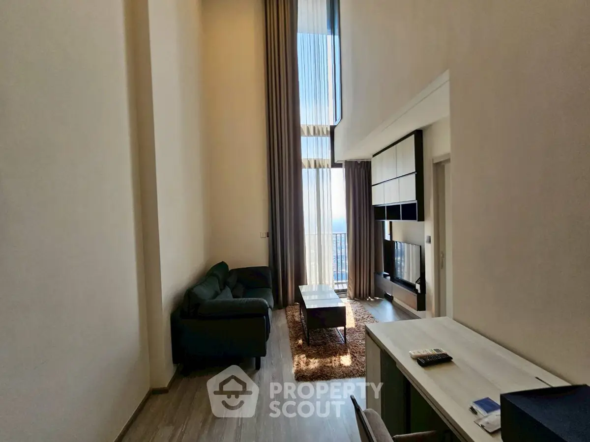 Modern high-ceiling living room with large windows and stylish furniture