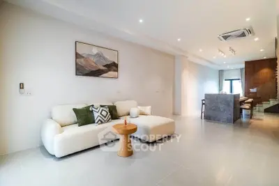 Spacious modern living room with elegant decor and open kitchen layout