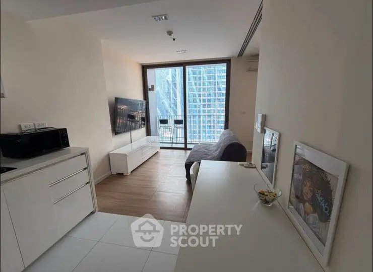 Modern living room with city view, sleek furniture, and open layout in high-rise apartment.