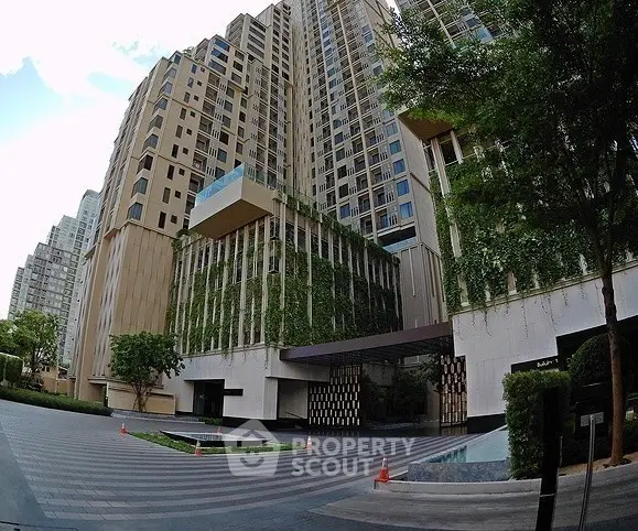 Luxurious modern high-rise building with lush greenery and elegant entrance