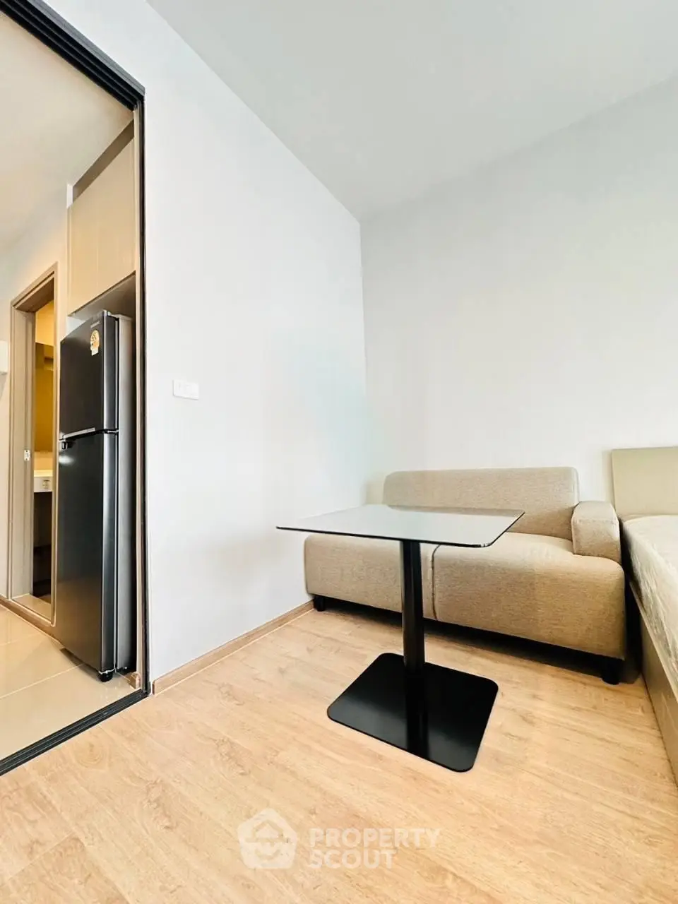 Modern living room with sleek furniture and wooden flooring in a contemporary apartment.