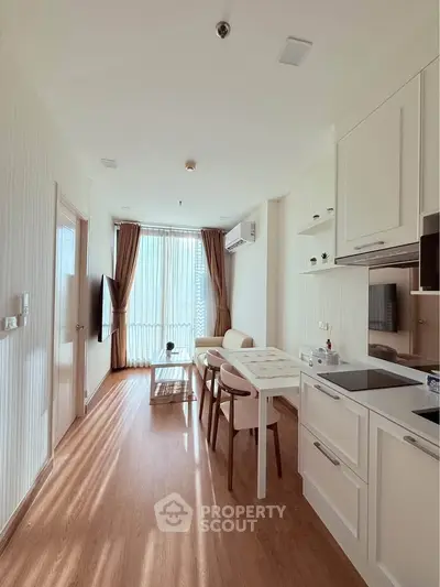 Bright and cozy open-layout kitchen and living area with modern furnishings.