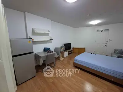 Cozy studio apartment with modern furnishings and wooden flooring