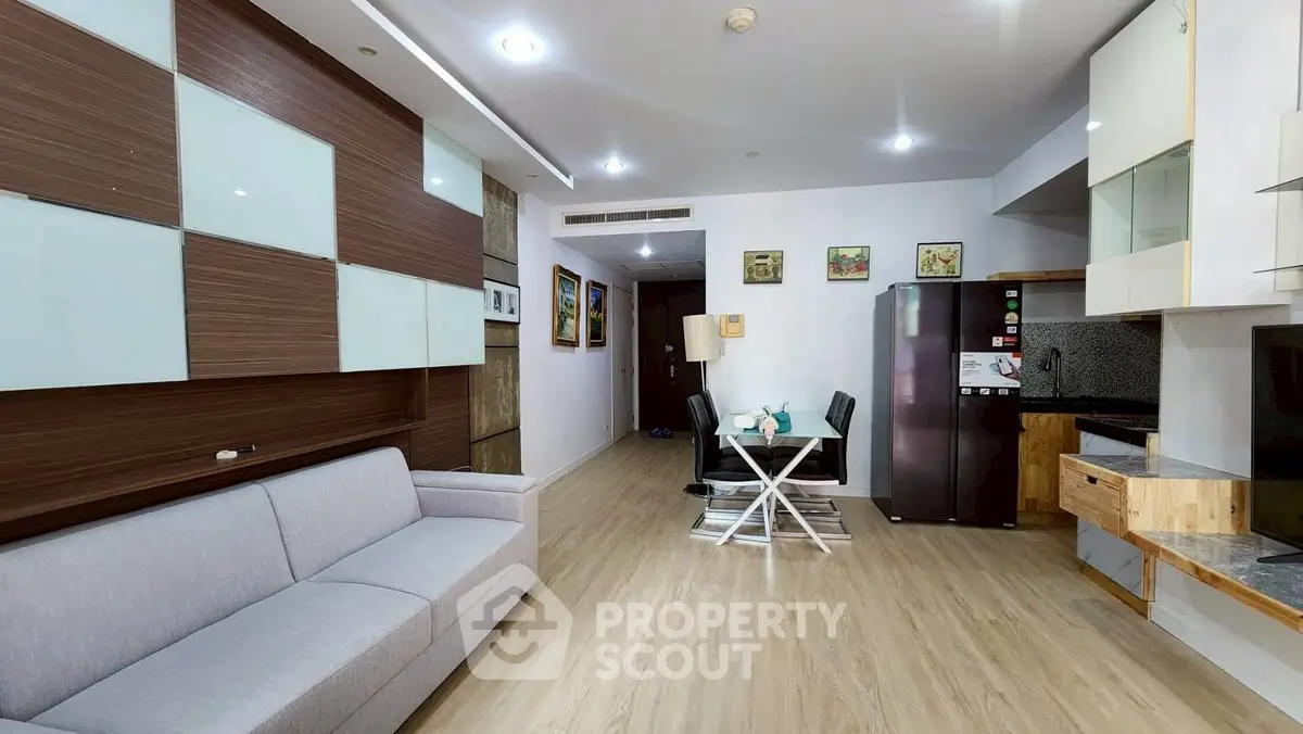 Modern living room with dining area and sleek kitchen appliances