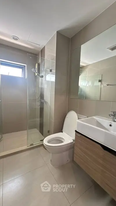 Modern bathroom with glass shower and sleek fixtures