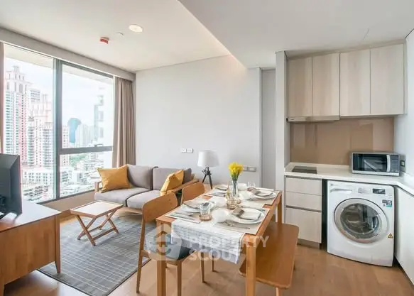 Modern open-plan living room with city view, featuring cozy seating and dining area, plus a compact kitchen.