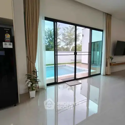 Modern living room with pool view through large glass doors