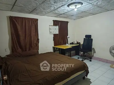 Cozy bedroom with study area, featuring a comfortable bed and work desk.