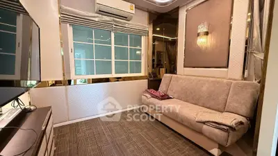 Cozy living room with modern decor and comfortable sofa in a stylish apartment.