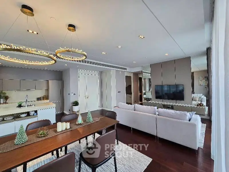 Luxurious open-plan living room with elegant dining area and modern kitchen in upscale apartment.