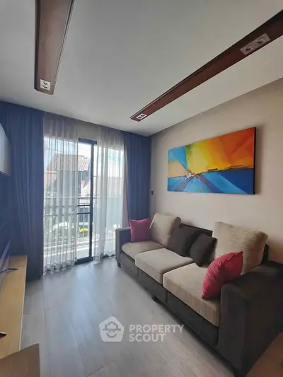 Modern living room with colorful artwork and natural light