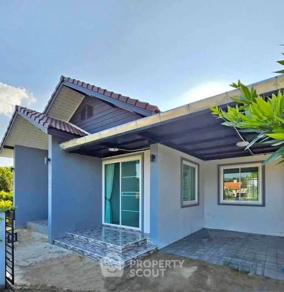 Charming single-story home with modern design and spacious front yard.