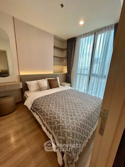 Cozy modern bedroom with large window and stylish decor