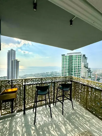 Luxurious balcony with stunning city and ocean view, perfect for relaxation and entertainment.
