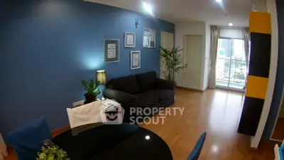Modern living room with blue accent wall, cozy sofa, and city view from balcony.