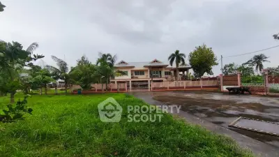 Stunning villa with lush garden and spacious driveway, perfect for luxurious living.