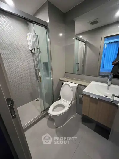 Modern bathroom with glass shower and sleek fixtures