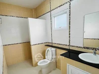 Spacious bathroom with modern fixtures and stylish tile design.