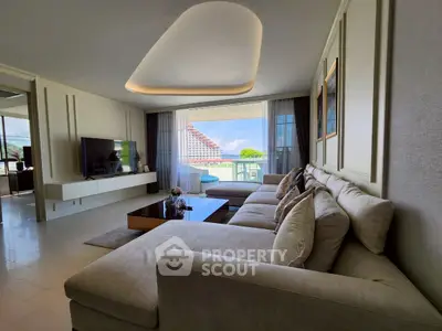 Luxurious living room with modern decor and stunning balcony view.