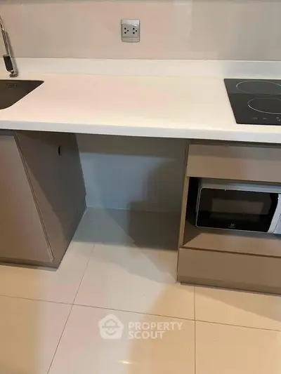 Modern kitchen with sleek countertop and built-in appliances, ideal for contemporary living.