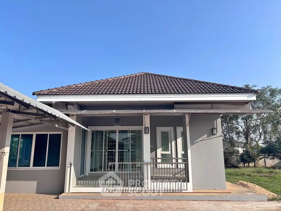 Charming single-story home with a tiled roof and spacious front patio, perfect for family living.