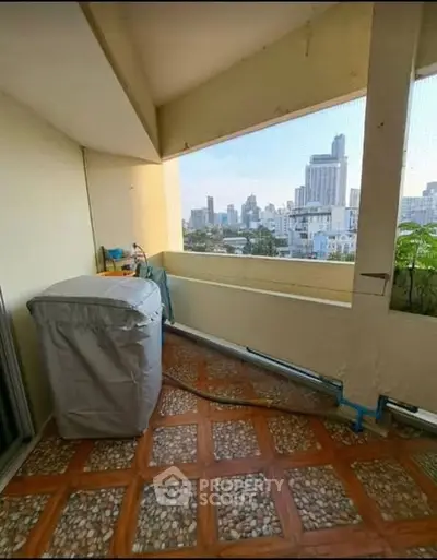 Spacious balcony with city skyline view, perfect for relaxation and enjoying urban scenery.