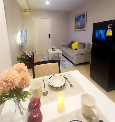 Cozy living room with modern decor and dining area in a stylish apartment.