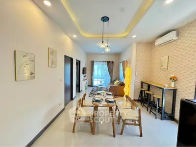 Modern living room with stylish dining area and cozy seating, featuring elegant lighting and contemporary decor.