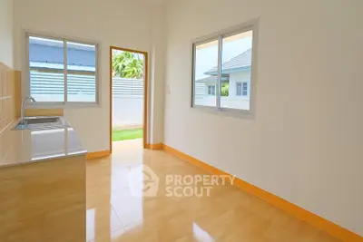 Bright and airy kitchen with open layout and garden view, perfect for modern living.