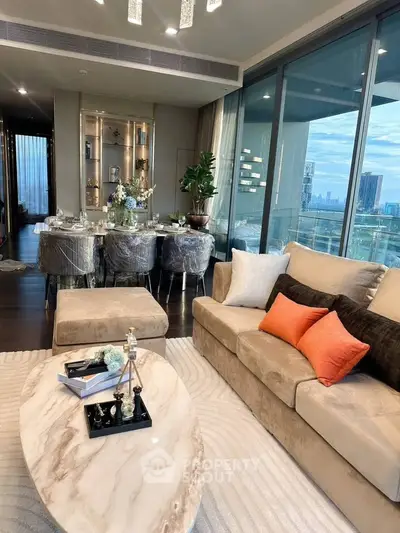 Luxurious living room with elegant decor and stunning city view from large windows.