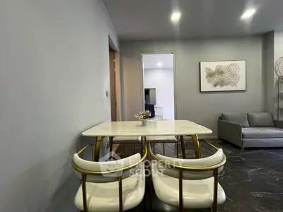 Modern dining area with marble table and stylish chairs in a contemporary living space.
