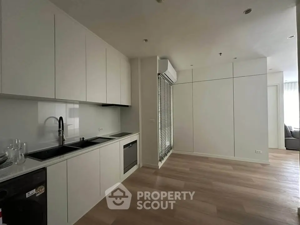 Modern kitchen with sleek cabinetry and built-in appliances in a stylish apartment.
