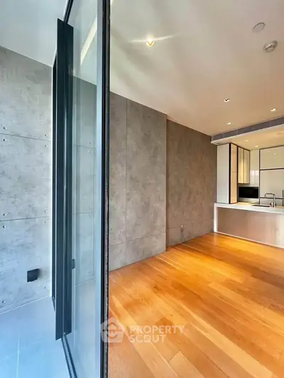 Modern open-plan kitchen with sleek design and wooden flooring