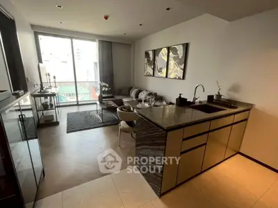 Modern open-layout living room with stylish kitchen and balcony view