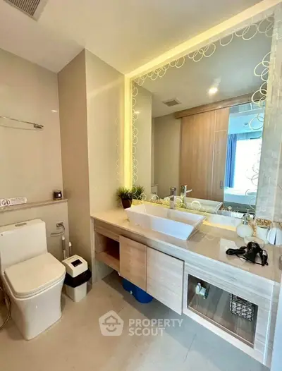 Modern bathroom with stylish vanity and illuminated mirror