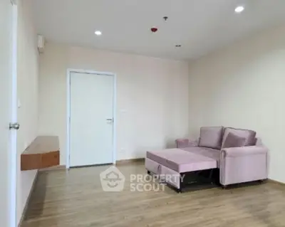 Spacious living room with modern sofa and wooden flooring