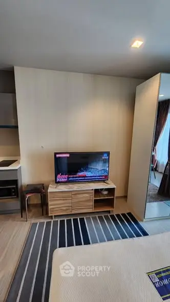 Modern living room with stylish TV setup and cozy decor in a contemporary apartment.