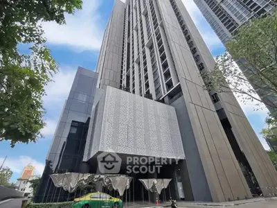 Modern high-rise building with sleek architectural design and urban surroundings.